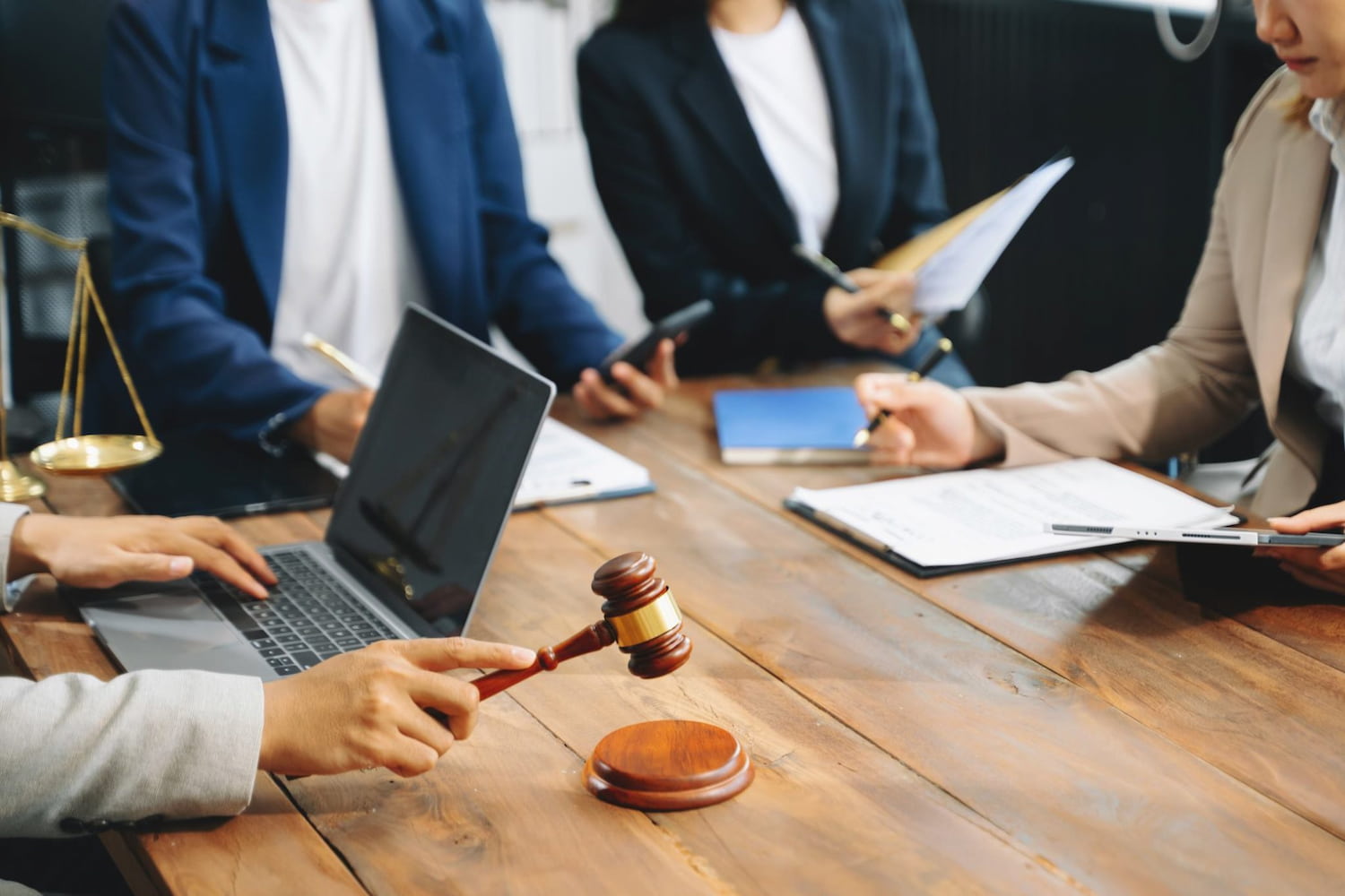 attorneys reviewing case material around a table